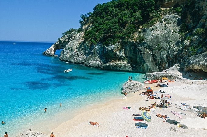 Cala Goloritzé beach in Sardinia with dramatic limestone cliffs and turquoise waters